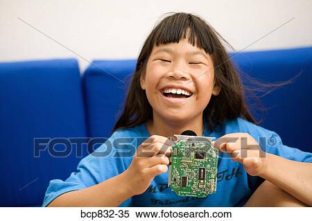 Portrait of a girl holding a circuit board and laughing View Large Photo Image Stock Photography - Portrait of a girl holding a circuit board and laughing. Fotosearch
