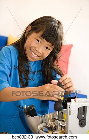 Portrait of a girl repairing a radio View Large Photo Image Stock Image - Portrait of a girl repairing a radio. Fotosearch