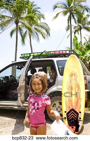 Portrait of a girl standing in front of a car and smiling View Large Photo Image Stock Image - Portrait of a girl standing in front of a car and smiling. Fotosearch