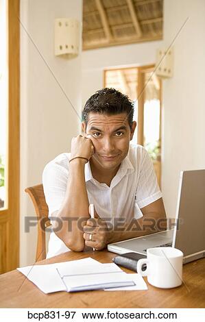Portrait of a man preparing home finance budget View Large Photo Image Stock Photo - Portrait of a man preparing home finance budget. Fotosearch