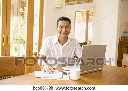 Portrait of a man preparing home finance budget View Large Photo Image Stock Photo - Portrait of a man preparing home finance budget. Fotosearch