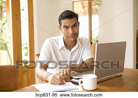 Portrait of a man signing a check and preparing home finance budget View Large Photo Image Stock Photography - Portrait of a man signing a check and preparing home finance budget. Fotosearch