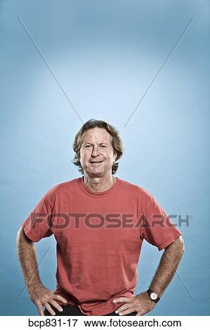 Portrait of a man sitting with arms akimbo View Large Photo Image Stock Photo - Portrait of a man sitting with arms akimbo. Fotosearch