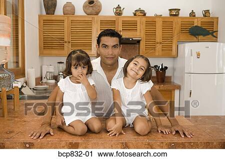 Portrait of a man with his daughters in the kitchen View Large Photo Image Stock Image - Portrait of a man with his daughters in the kitchen. Fotosearch