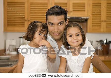 Portrait of a man with his daughters in the kitchen View Large Photo Image Stock Image - Portrait of a man with his daughters in the kitchen. Fotosearch