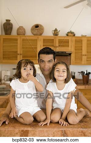 Portrait of a man with his daughters in the kitchen View Large Photo Image Stock Image - Portrait of a man with his daughters in the kitchen. Fotosearch