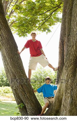 Two friends playing in a park View Large Photo Image Stock Image - Two friends playing in a park. Fotosearch