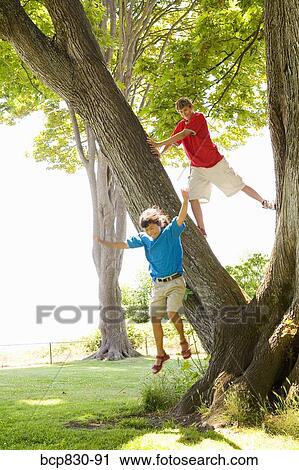 Stock Image - Two friends playing in a park. Fotosearch