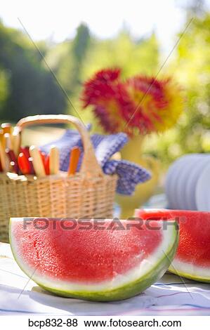 Two watermelon slices with a basket on a table View Large Photo Image Stock Photo - Two watermelon slices with a basket on a table. Fotosearch