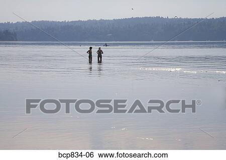 Two women standing in the sea, Washington State, USA View Large Photo Image Stock Photograph - Two women standing in the sea, Washington State, USA. Fotosearch