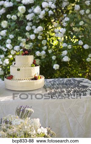 Stock Photo - Wedding cake and forks on a table. Fotosearch