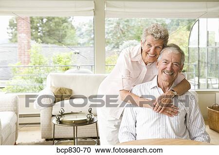 Woman embracing a man from behind View Large Photo Image Stock Image - Woman embracing a man from behind. Fotosearch
