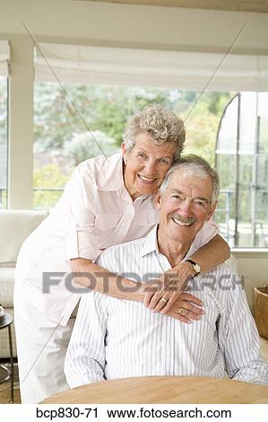 Woman embracing a man from behind View Large Photo Image Stock Image - Woman embracing a man from behind. Fotosearch