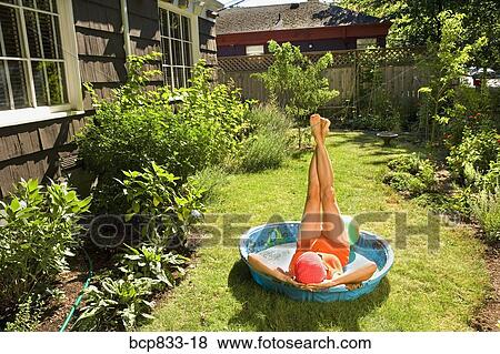 Woman lying in a wading pool with her feet up View Large Photo Image Stock Photo - Woman lying in a wading pool with her feet up. Fotosearch