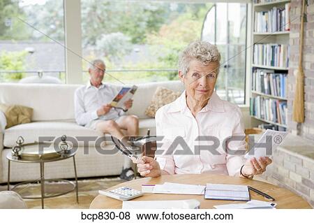 Woman preparing home finance budget View Large Photo Image Stock Photo - Woman preparing home finance budget. Fotosearch