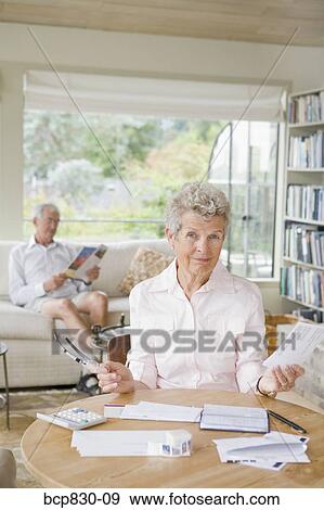 Woman preparing home finance budget View Large Photo Image Stock Photo - Woman preparing home finance budget. Fotosearch