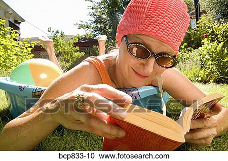 Woman reading a book in a wading pool View Large Photo Image Stock Image - Woman reading a book in a wading pool. Fotosearch