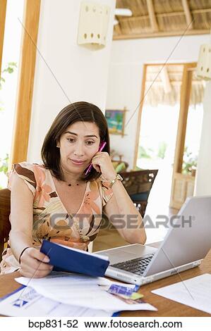 Woman sitting in front of a laptop and thinking View Large Photo Image Stock Image - Woman sitting in front of a laptop and thinking. Fotosearch