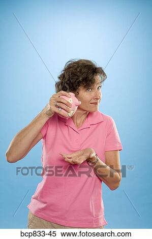 Woman trying to get money out of a piggy bank View Large Photo Image Stock Photography - Woman trying to get money out of a piggy bank. Fotosearch