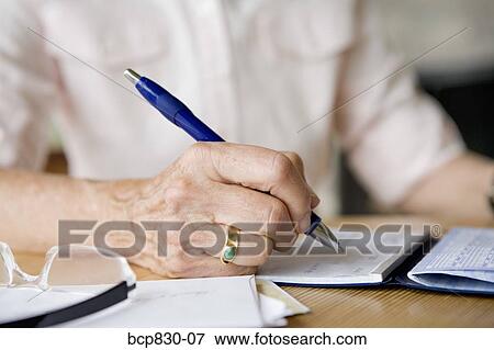 Woman writing on a diary View Large Photo Image Stock Photo - Woman writing on a diary. Fotosearch