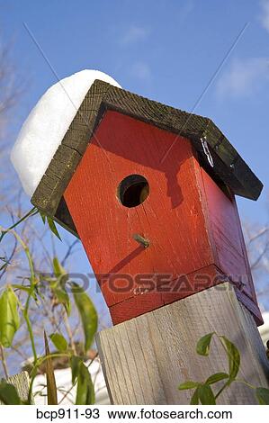 Bird House Perched On A Fence Post During Winter Stock Image