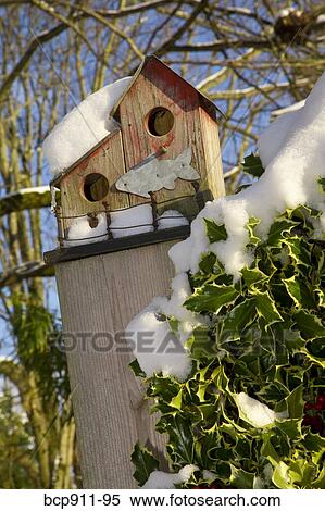 Bird House Perched On A Fence Post During Winter Stock Photography