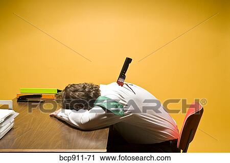 Stock Image - Deceased man in office stabbed in the back. Fotosearch
