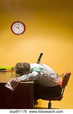 Stock Photography - Deceased man in office stabbed in the back. Fotosearch