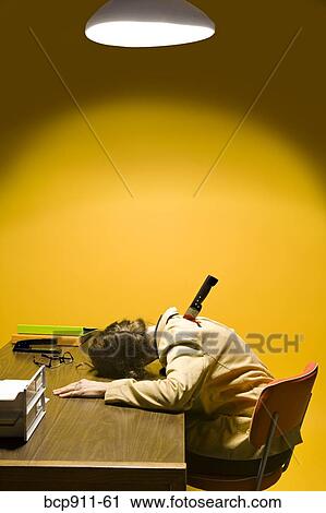 Stock Image - Deceased woman in office stabbed in the back. Fotosearch