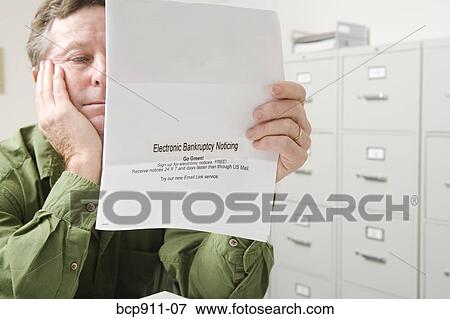 Distraught Man with bankruptcy notice View Large Photo Image Stock Photo - Distraught Man with bankruptcy notice. Fotosearch