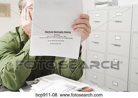 Distraught Man with bankruptcy notice View Large Photo Image Stock Photo - Distraught Man with bankruptcy notice. Fotosearch