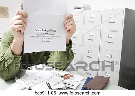 Distraught Man with bankruptcy notice View Large Photo Image Stock Photograph - Distraught Man with bankruptcy notice. Fotosearch