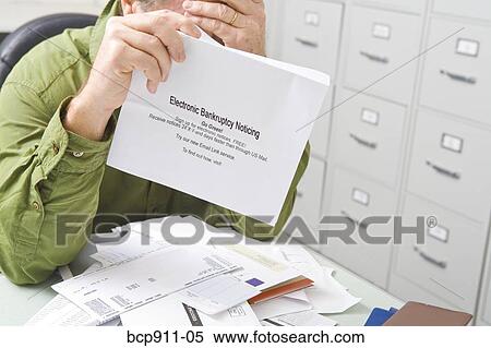 Stock Photography - Distraught Man with bankruptcy notice. Fotosearch