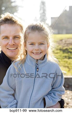 Father and daughter smiling outdoors View Large Photo Image Stock Photo - Father and daughter smiling outdoors. Fotosearch