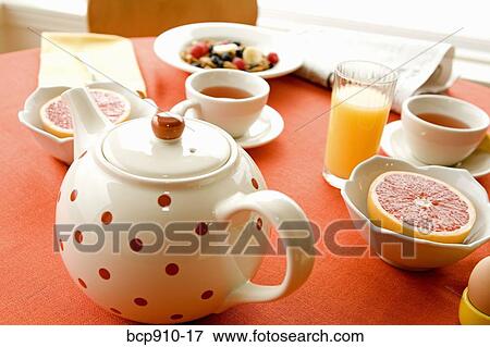Stock Photo - Healthy breakfast of dry cereal and fruit with tea. Fotosearch