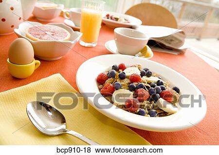 Healthy breakfast of dry cereal and fruit with egg and juice View Large Photo Image Stock Photo - Healthy breakfast of dry cereal and fruit with egg and juice. Fotosearch