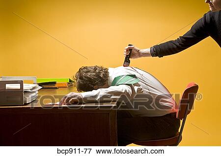 Stock Photo - Man in office being stabbed in the back. Fotosearch