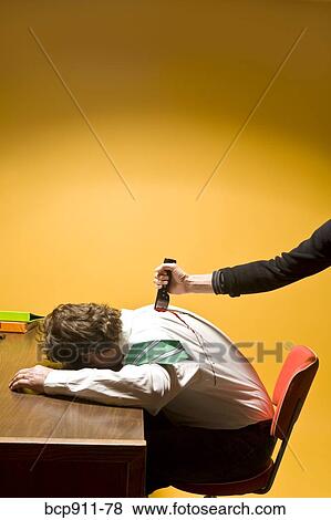 Stock Photo - Man in office being stabbed in the back. Fotosearch
