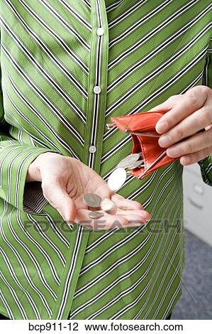 Woman emptying coins from coin purse View Large Photo Image Stock Image - Woman emptying coins from coin purse. Fotosearch