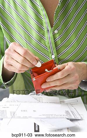 Woman holding a coin purse and coin View Large Photo Image Stock Image - Woman holding a coin purse and coin. Fotosearch
