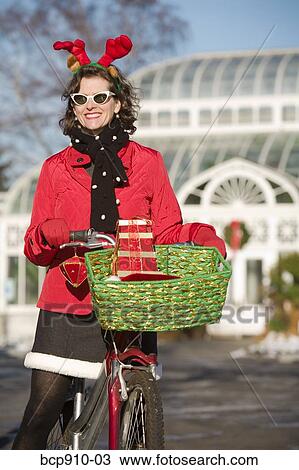 Woman in Christmas attire on a bicycle ride View Large Photo Image Stock Image - Woman in Christmas attire on a bicycle ride. Fotosearch