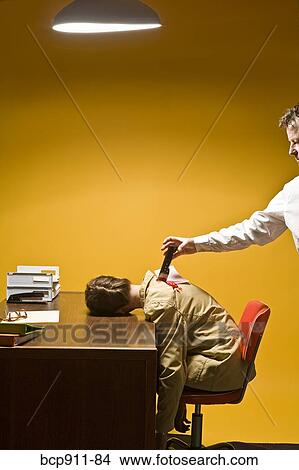 Picture - Woman in office being stabbed in the back. Fotosearch