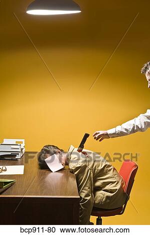 Stock Image - Woman in office being stabbed in the back. Fotosearch