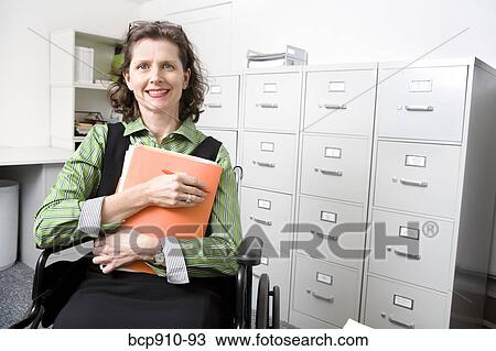 Woman in wheelchair holding files View Large Photo Image Stock Image - Woman in wheelchair holding files. Fotosearch