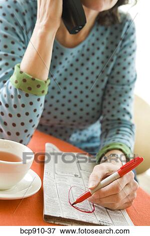 Woman researching classifieds View Large Photo Image Stock Photo - Woman researching classifieds. Fotosearch