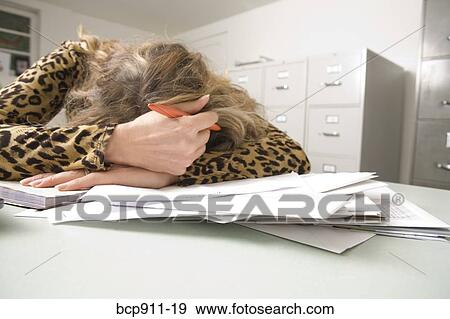 Woman resting head on table while writing checks View Large Photo Image Stock Photo - Woman resting head on table while writing checks. Fotosearch
