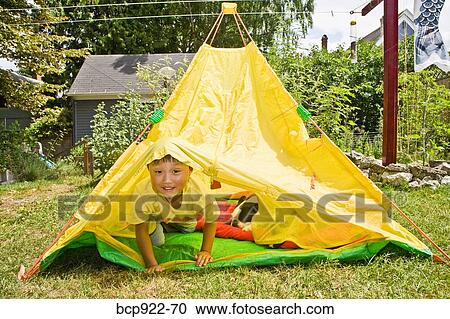 Boy with dogs in backyard tent View Large Photo Image Stock Image - Boy with dogs in backyard tent. Fotosearch