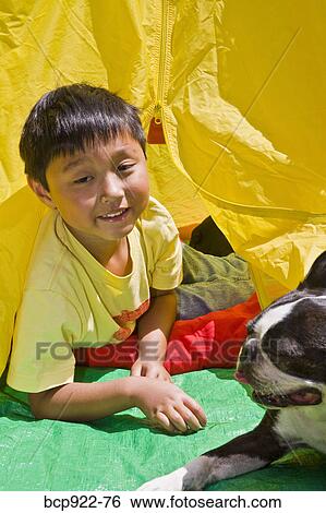 Boy with dogs in backyard tent View Large Photo Image Stock Photograph - Boy with dogs in backyard tent. Fotosearch