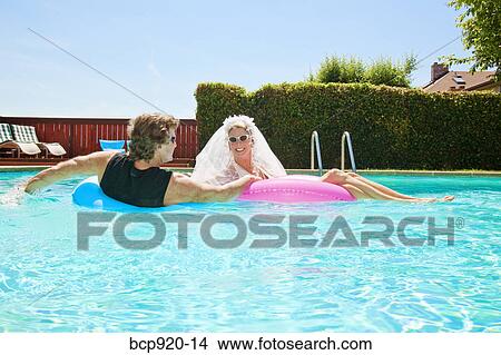 Bride and groom in swimming pool View Large Photo Image Picture - Bride and groom in swimming pool. Fotosearch