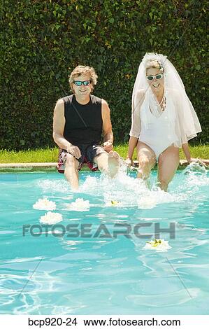 Bride and groom in swimming pool View Large Photo Image Picture - Bride and groom in swimming pool. Fotosearch